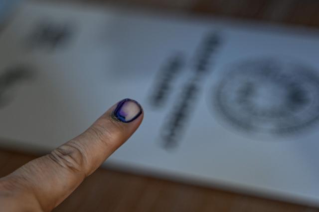 A voter's finger is seen marked with indelible ink at a polling station during the midterm elections in Manila on May 12, 2025. Millions of Filipinos headed to the polls May 12 in a mid-term election widely seen as a referendum on the explosive feud between President Ferdinand Marcos and impeached Vice President Sara Duterte. (Photo by Jam STA ROSA / AFP)