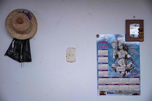 A calendar with an image of the Divine Child hangs from a wall in a housein the Eten district, Lambayeque region, northern Peru on May 10, 2025. In the small town of Eten the faithful flock every year to celebrate the miracle of the Divine Child, a sacred phenomenon not yet recognised by the Vatican. The election of Leo XIV, former bishop of the diocese, has revived hopes for official recognition, as well as for the construction of a sanctuary worthy of this Eucharistic miracle, the only one of its kind reported in Peru. (Photo by ERNESTO BENAVIDES / AFP)