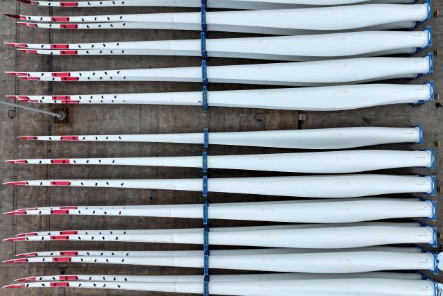 This photo taken on May 10, 2025 shows wind turbine blades waiting to be loaded onto a ship for export at the port in Lianyungang, in China’s eastern Jiangsu province. (Photo by AFP) / China OUT