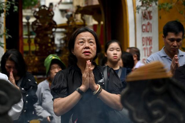 Buddhist devotees pray at the Quan Su Pagoda in Hanoi on May 12, 2025, as Buddhists celebrated Vesak Day, or Buddha Day, which marks the Buddha's birth. (Photo by Nhac NGUYEN / AFP)