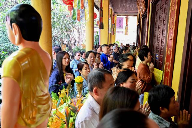 Buddhist devotees pray at the Quan Su Pagoda in Hanoi on May 12, 2025, as Buddhists celebrated Vesak Day, or Buddha Day, which marks the Buddha's birth. (Photo by Nhac NGUYEN / AFP)