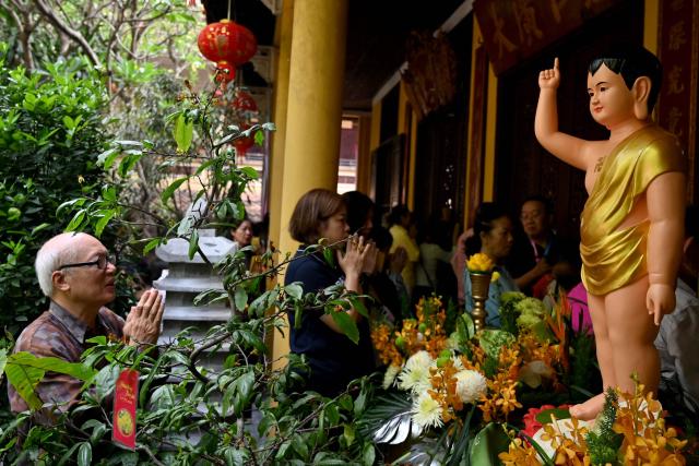 A man prays at the Quan Su Pagoda in Hanoi on May 12, 2025, as Buddhists celebrated Vesak Day, or Buddha Day, which marks the Buddha's birth. (Photo by Nhac NGUYEN / AFP)