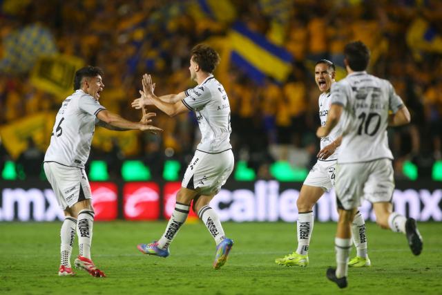 Necaxa's midfielder #08 Agustin Palavecino (2nd-L) celebrates with teammates after scoring his team's first goal during the Liga MX Clausura tournament quarter-final second leg football match between Tigres and Necaxa at the UANL University Stadium in San Nicolás de los Garza, Nuevo Leon state, Mexico on May 11, 2025. (Photo by Julio Cesar AGUILAR / AFP)