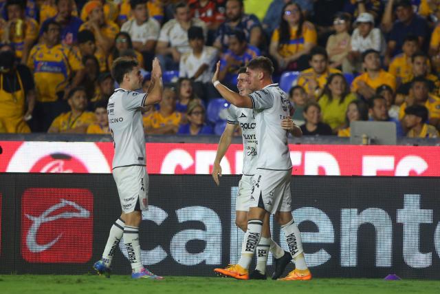 Necaxa's forward #09 Tomas Badaloni (R) celebrates with teammates after scoring his team's second goal during the Liga MX Clausura tournament quarter-final second leg football match between Tigres and Necaxa at the UANL University Stadium in San Nicolás de los Garza, Nuevo Leon state, Mexico on May 11, 2025. (Photo by Julio Cesar AGUILAR / AFP)