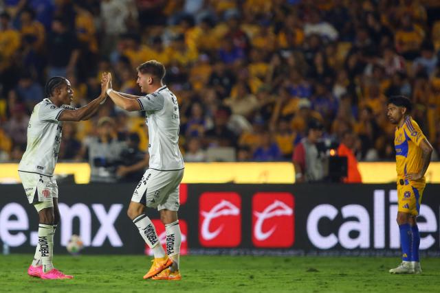 Necaxa's forward #09 Tomas Badaloni (2nd-R) celebrates with teammate Colombian forward #27 Diber Cambindo after scoring his team's second goal during the Liga MX Clausura tournament quarter-final second leg football match between Tigres and Necaxa at the UANL University Stadium in San Nicolás de los Garza, Nuevo Leon state, Mexico on May 11, 2025. (Photo by Julio Cesar AGUILAR / AFP)