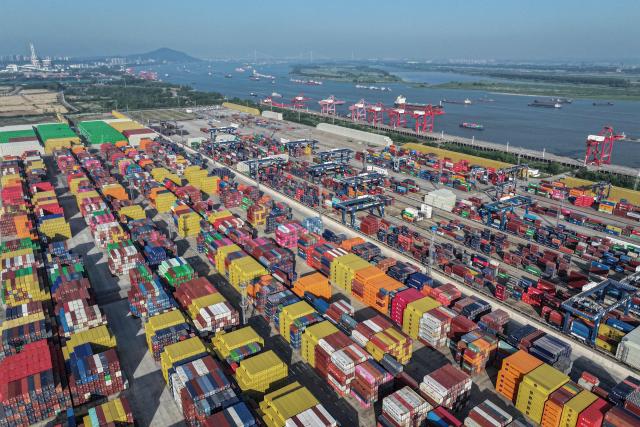 Containers are stacked at a port in Nanjing, in eastern China's Jiangsu province on May 12, 2025. (Photo by AFP) / China OUT