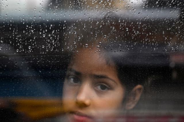 A girl looks through the window of a car as she returns to her hometown following India-Pakistan ceasefire, in Uri, about 100kms from Srinagar on May 11, 2025. Indian and Pakistani military chiefs were set to confer on May 12 as a ceasefire that brought the nuclear-armed rivals back from the brink of all-out war held. US President Donald Trump announced the truce late on May 10 after four days of missile, drone and artillery attacks which killed at least 60 people and sent thousands fleeing on both sides. (Photo by Tauseef MUSTAFA / AFP)