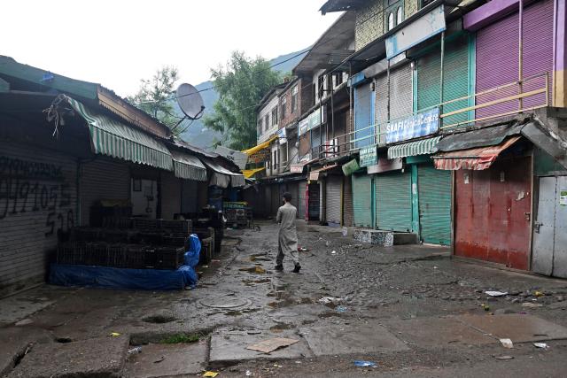 A man walks through a closed market in Uri, about 100kms from Srinagar on May 11, 2025. Indian and Pakistani military chiefs were set to confer on May 12 as a ceasefire that brought the nuclear-armed rivals back from the brink of all-out war held. US President Donald Trump announced the truce late on May 10 after four days of missile, drone and artillery attacks which killed at least 60 people and sent thousands fleeing on both sides. (Photo by Tauseef MUSTAFA / AFP)