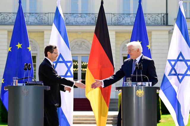 German President Frank-Walter Steinmeier (R) and his Israeli counterpart Isaac Herzog shake hands during a joint press conference following talks at the Presidential Bellevue Palace, on May 12, 2025 in Berlin. Israel's President Isaac Herzog visits Germany to mark the 60th anniversary of diplomatic relations between the two countries. (Photo by John MACDOUGALL / AFP)