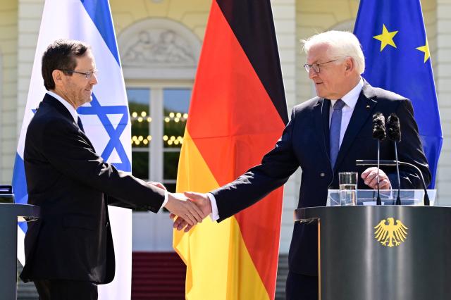 German President Frank-Walter Steinmeier (R) and his Israeli counterpart Isaac Herzog shake hands during a joint press conference following talks at the Presidential Bellevue Palace, on May 12, 2025 in Berlin. Israel's President Isaac Herzog visits Germany to mark the 60th anniversary of diplomatic relations between the two countries. (Photo by John MACDOUGALL / AFP)