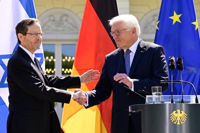 German President Frank-Walter Steinmeier (R) and his Israeli counterpart Isaac Herzog shake hands during a joint press conference following talks at the Presidential Bellevue Palace, on May 12, 2025 in Berlin. Israel's President Isaac Herzog visits Germany to mark the 60th anniversary of diplomatic relations between the two countries. (Photo by John MACDOUGALL / AFP)