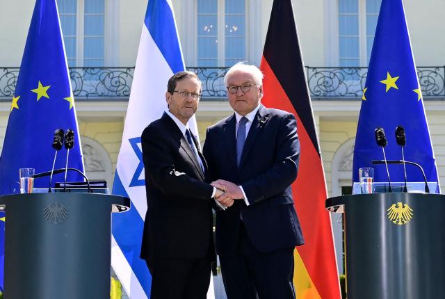 German President Frank-Walter Steinmeier (R) and his Israeli counterpart Isaac Herzog shake hands after addressing a joint press conference after talks at the Presidential Bellevue Palace, on May 12, 2025 in Berlin. Israel's President Isaac Herzog visits Germany to mark the 60th anniversary of diplomatic relations between the two countries. (Photo by John MACDOUGALL / AFP)