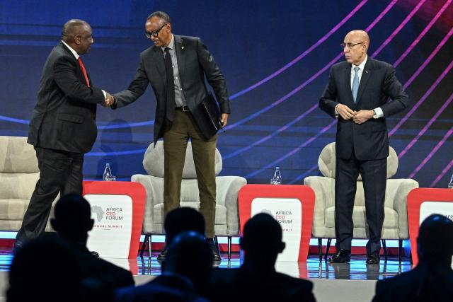 South Africa's President Cyril Ramaphosa (L) shakes hands with Rwanda's President Paul Kagame (C) as Mauritania's President Mohamed Ould Ghazouani (R) looks on after taking part in a presidential panel at the opening ceremony of the Africa CEO Forum annual summit in Abidjan on May 12, 2025. (Photo by Issouf SANOGO / AFP)
