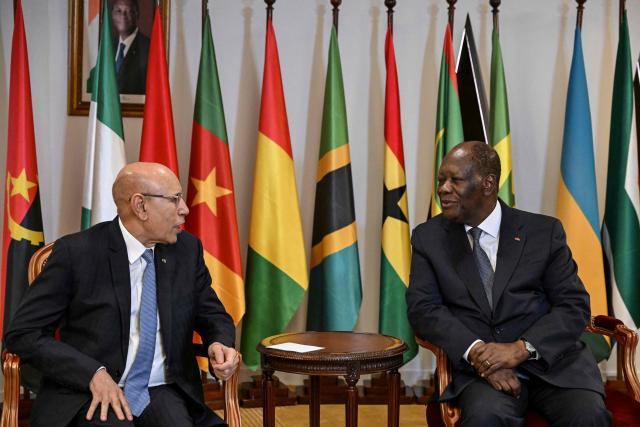 Ivory Coast's President Alassane Ouattara (R) meets with Mauritania's President Mohamed Ould Ghazouani at the opening ceremony of the Africa CEO Forum annual summit in Abidjan on May 12, 2025. (Photo by Issouf SANOGO / AFP)