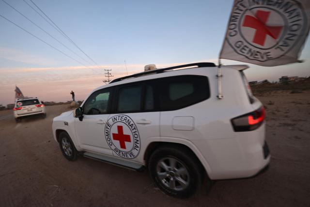 International Red Cross (ICRC) vehicles drive in Deir el-Balah as they transport US-Israeli hostage Edan Alexander on May 12, 2025, after being handed over by Al-Qassam Brigades. Palestinian militant group Hamas said its armed wing handed over a US-Israeli hostage held in Gaza since October 2023 on Monday, ahead of a regional visit by US President Donald Trump. (Photo by Eyad BABA / AFP)