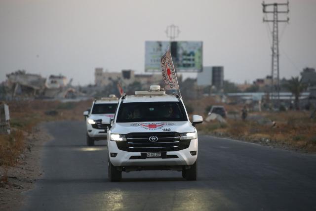 TOPSHOT - International Red Cross (ICRC) vehicles drive in Deir el-Balah as they transport US-Israeli hostage Edan Alexander on May 12, 2025, after being handed over by Al-Qassam Brigades. Palestinian militant group Hamas said its armed wing handed over a US-Israeli hostage held in Gaza since October 2023 on Monday, ahead of a regional visit by US President Donald Trump. (Photo by Eyad BABA / AFP)