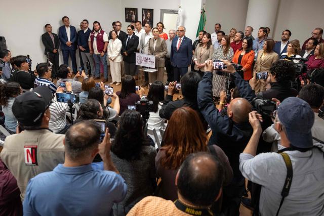 Baja California Governor Marina del Pilar Avila (C), accompanied by members of her cabinet, delivers a statement on the revocation of her visa by US authorities in Tijuana, Baja California State, Mexico, on May 12, 2025. (Photo by Guillermo Arias / AFP)