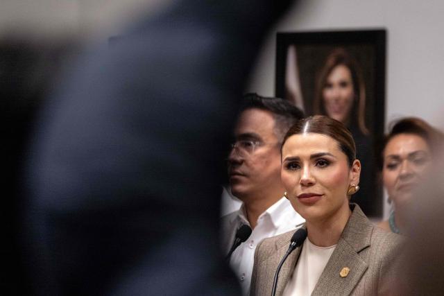 Baja California Governor Marina del Pilar Avila, accompanied by members of her cabinet, looks on as she delivers a statement on the revocation of her visa by US authorities in Tijuana, Baja California State, Mexico, on May 12, 2025. (Photo by Guillermo Arias / AFP)