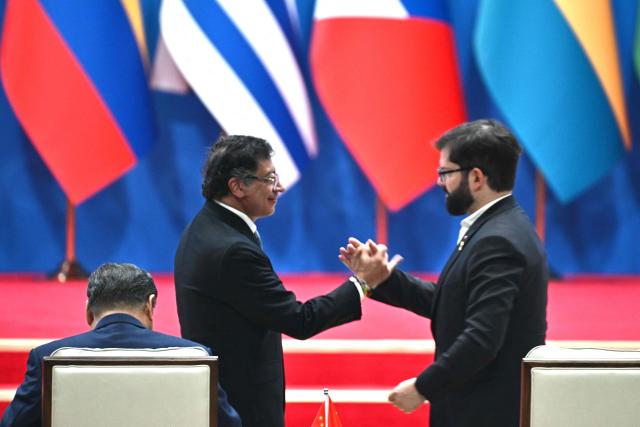 Chile’s President Gabriel Boric (R) and Colombia’s President Gustavo Petro shake hands during the opening ceremony of the Fourth Ministerial Meeting of the Forum of China and Community of Latin American and Caribbean States (CELAC) in Beijing on May 13, 2025. (Photo by Pedro Pardo / AFP)