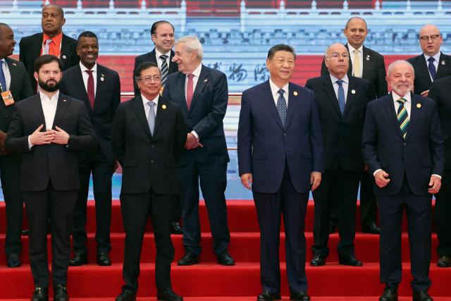 Chinese President Xi Jinping (front 2nd R), Brazil President Luiz Inacio Lula da Silva (front R), Chile President President Gabriel Boric (front L) and Colombia President Gustavo Petro (front 2nd L) attend a group photo session before the opening ceremony of the Fourth Ministerial Meeting of the Forum of China and Community of Latin American and Caribbean States (CELAC) in Beijing on May 13, 2025. (Photo by FLORENCE LO / POOL / AFP)