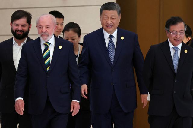 Chinese President Xi Jinping (C), Brazil President Luiz Inacio Lula da Silva (2nd L), Chile President President Gabriel Boric (L) and Colombia President Gustavo Petro (R) arrive for a group photo session before the opening ceremony of the Fourth Ministerial Meeting of the Forum of China and Community of Latin American and Caribbean States (CELAC) in Beijing on May 13, 2025. (Photo by FLORENCE LO / POOL / AFP)