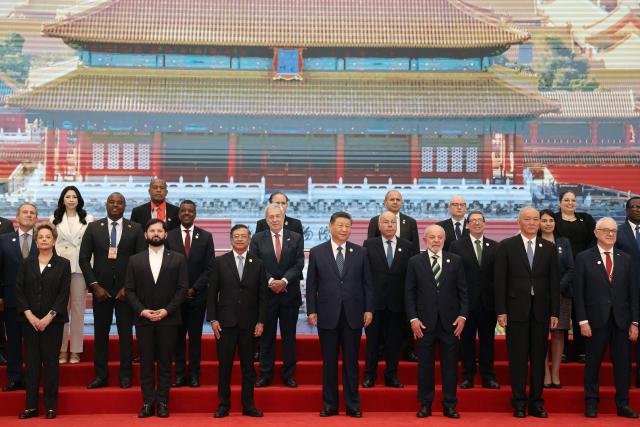Chinese President Xi Jinping (C), Brazil President Luiz Inacio Lula da Silva (front 3rd R), Chile President President Gabriel Boric (front 2nd L), Colombia President Gustavo Petro (front 3rd L) and other CELAC representatives attend a group photo session before the opening ceremony of the Fourth Ministerial Meeting of the Forum of China and Community of Latin American and Caribbean States (CELAC) in Beijing on May 13, 2025. (Photo by FLORENCE LO / POOL / AFP)