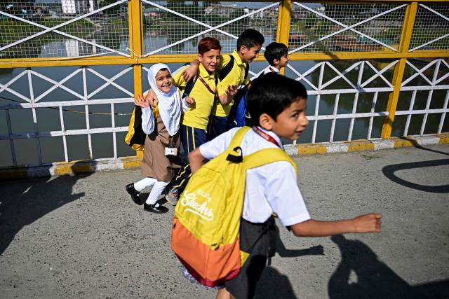 Students walk to attend classes as their school reopened after a ceasefire between Pakistan and India, in Srinagar on May 13, 2025. Indian Prime Minister Narendra Modi vowed on May 12 to respond strongly to any future "terrorist attack", and warned that New Delhi would not tolerate "nuclear blackmail" in the event of further conflict with Pakistan. (Photo by SAJJAD HUSSAIN / AFP)