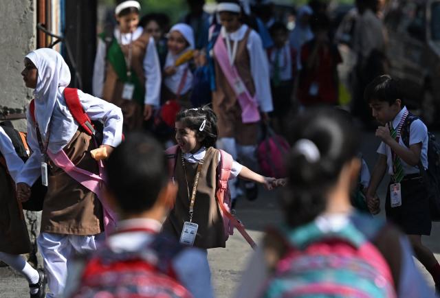 Students walk to attend classes as their school reopened after a ceasefire between Pakistan and India, in Srinagar on May 13, 2025. Indian Prime Minister Narendra Modi vowed on May 12 to respond strongly to any future "terrorist attack", and warned that New Delhi would not tolerate "nuclear blackmail" in the event of further conflict with Pakistan. (Photo by SAJJAD HUSSAIN / AFP)