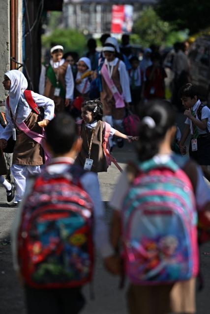 Students walk to attend classes as their school reopened after a ceasefire between Pakistan and India, in Srinagar on May 13, 2025. Indian Prime Minister Narendra Modi vowed on May 12 to respond strongly to any future "terrorist attack", and warned that New Delhi would not tolerate "nuclear blackmail" in the event of further conflict with Pakistan. (Photo by SAJJAD HUSSAIN / AFP)
