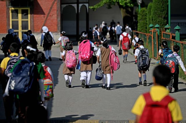 Students walk to attend classes as their school reopened after a ceasefire between Pakistan and India, in Srinagar on May 13, 2025. Indian Prime Minister Narendra Modi vowed on May 12 to respond strongly to any future "terrorist attack", and warned that New Delhi would not tolerate "nuclear blackmail" in the event of further conflict with Pakistan. (Photo by SAJJAD HUSSAIN / AFP)