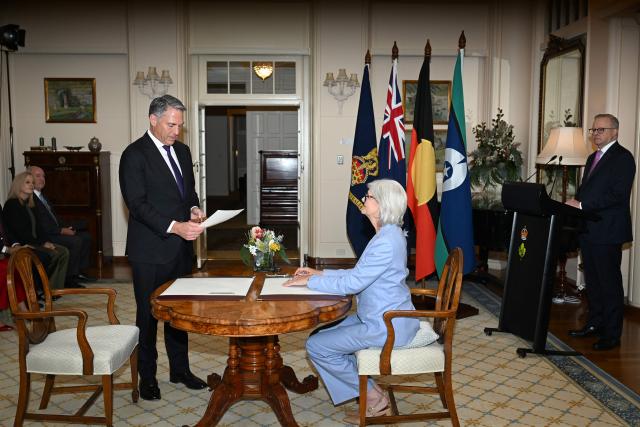 Australian Deputy Prime Minister Richard Marles (L) is sworn in by Australian Governor-General Sam Mostyn during a ceremony at Government House in Canberra on May 13, 2025. (Photo by Saeed Khan / AFP)