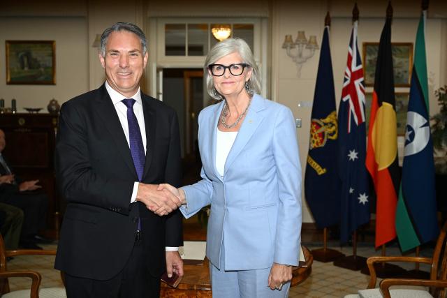 Australian Deputy Prime Minister Richard Marles (L) shakes hands with Australian Governor-General Sam Mostyn during a swearing-in ceremony at Government House in Canberra on May 13, 2025. (Photo by Saeed Khan / AFP)