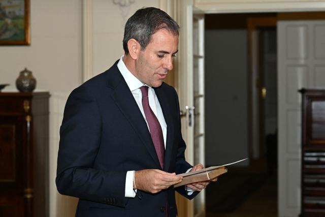 Australian Treasurer Jim Chalmers is sworn in by Australian Governor-General Sam Mostyn during a swearing-in ceremony at Government House in Canberra on May 13, 2025. (Photo by Saeed Khan / AFP)