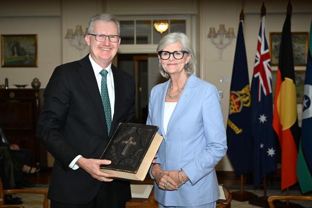 Australian Home Affairs Minister Tony Burke (L) poses for photographs with Australian Governor-General Sam Mostyn during a swearing-in ceremony at Government House in Canberra on May 13, 2025. (Photo by Saeed Khan / AFP)