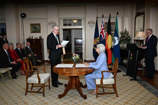 Australian Home Affairs Minister Tony Burke (C) is sworn in by Australian Governor-General Sam Mostyn during a swearing-in ceremony at Government House in Canberra on May 13, 2025. (Photo by Saeed Khan / AFP)