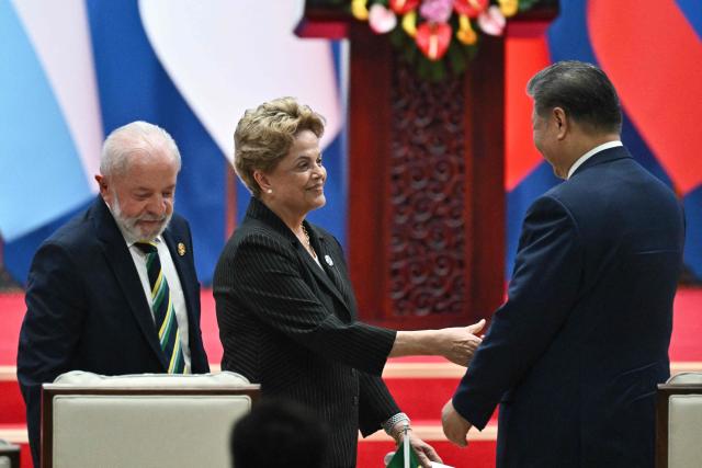 Brazil’s President Luiz Inacio Lula da Silva (L), Dilma Rousseff, Chair of the New Development Bank and former president of Brazil (C) and China’s President Xi Jinping attend the opening ceremony of the Fourth Ministerial Meeting of the Forum of China and Community of Latin American and Caribbean States (CELAC) in Beijing on May 13, 2025. (Photo by Pedro PARDO / AFP)