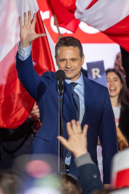 Warsaw's mayor and member of Poland’s ruling Civic Coalition party Rafal Trzaskowski cheers his supporters after the presidential debate in Polish National Television headquarters in Warsaw on May 12, 2025. Poland will hold presidential election on May 18, 2025. (Photo by Wojtek RADWANSKI / AFP)