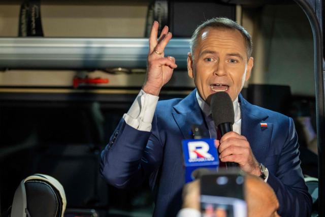 Karol Nawrocki, candidate for the 2025 Polish presidential election supported by Poland's right-wing Law and Justice (PiS) party, adresses supporters from his campaign van after a presidential debate at the Polish National Television headquarters in Warsaw on May 12, 2025. Poland will hold presidential election on May 18, 2025. (Photo by Wojtek RADWANSKI / AFP)