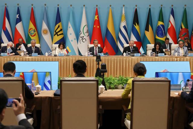 Chinese Foreign Minister Wang Yi (C) speaks during the plenary session of the Fourth Ministerial Meeting of the Forum of China and Community of Latin American and Caribbean States (CELAC) in Beijing on May 13, 2025. (Photo by FLORENCE LO / POOL / AFP)