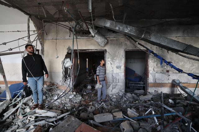 EDITORS NOTE: Graphic content / Palestinians inspect the destruction inside Nasser hospital in Khan Yunis in the southern Gaza Strip following an Israeli strike early on May 13, 2025, in which Palestinian journalist Hassan Aslih was killed along with several others. The Israeli military said it struck a Gaza hospital "housing Hamas militants" in a raid on May 13 which, according to the Palestinian group, killed the journalist who had been wounded in an Israeli attack last month and a number of civilians. (Photo by Eyad BABA / AFP)