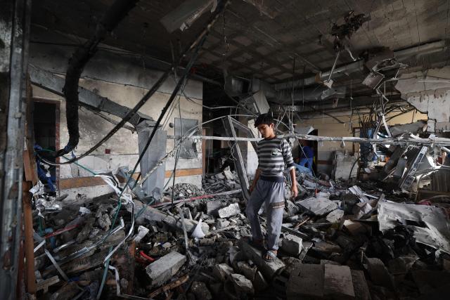 EDITORS NOTE: Graphic content / A Palestinian youth inspects the destruction inside Nasser hospital in Khan Yunis in the southern Gaza Strip, following an Israeli strike early on May 13, 2025 in which Palestinian journalist Hassan Aslih was killed along with several others. The Israeli military said it struck a Gaza hospital "housing Hamas militants" in a raid on May 13 which, according to the Palestinian group, killed the journalist who had been wounded in an Israeli attack last month and a number of civilians. (Photo by Eyad BABA / AFP)