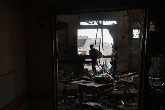 EDITORS NOTE: Graphic content / Palestinian youths inspect the destruction inside Nasser hospital in Khan Yunis in the southern Gaza Strip following an Israeli strike early on May 13, 2025, in which Palestinian journalist Hassan Aslih was killed along with several others. The Israeli military said it struck a Gaza hospital "housing Hamas militants" in a raid on May 13 which, according to the Palestinian group, killed the journalist who had been wounded in an Israeli attack last month and a number of civilians. (Photo by Eyad BABA / AFP)