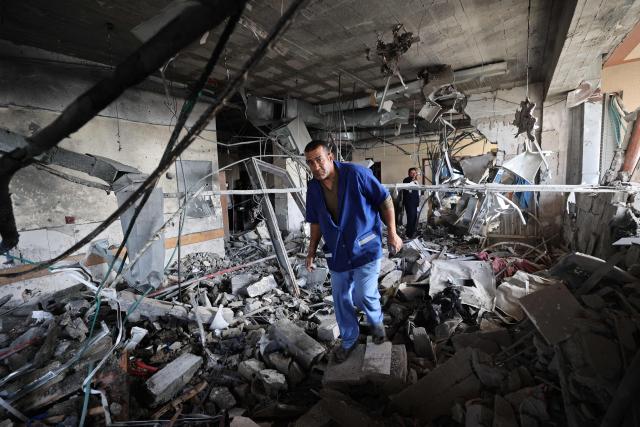 EDITORS NOTE: Graphic content / Palestinian hospital staff inspect the destruction inside Nasser hospital in Khan Yunis in the southern Gaza Strip, following an Israeli strike early on May 13, 2025 in which Palestinian journalist Hassan Aslih was killed along with several others. The Israeli military said it struck a Gaza hospital "housing Hamas militants" in a raid on May 13 which, according to the Palestinian group, killed the journalist who had been wounded in an Israeli attack last month and a number of civilians. (Photo by Eyad BABA / AFP)