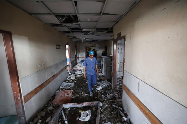 EDITORS NOTE: Graphic content / Palestinian hospital staff inspect the destruction inside Nasser hospital in Khan Yunis in the southern Gaza Strip, following an Israeli strike early on May 13, 2025 in which Palestinian journalist Hassan Aslih was killed along with several others. The Israeli military said it struck a Gaza hospital "housing Hamas militants" in a raid on May 13 which, according to the Palestinian group, killed the journalist who had been wounded in an Israeli attack last month and a number of civilians. (Photo by Eyad BABA / AFP)
