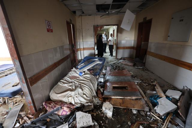 EDITORS NOTE: Graphic content / TOPSHOT - Palestinians inspect the destruction inside Nasser hospital in Khan Yunis in the southern Gaza Strip following an Israeli strike early on May 13, 2025, in which Palestinian journalist Hassan Aslih was killed along with several others. The Israeli military said it struck a Gaza hospital "housing Hamas militants" in a raid on May 13 which, according to the Palestinian group, killed the journalist who had been wounded in an Israeli attack last month and a number of civilians. (Photo by Eyad BABA / AFP)