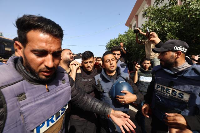 EDITORS NOTE: Graphic content / Palestinian journalists walk in the funeral procession of their colleague Hassan Aslih, killed at dawn in an Israeli strike which hit the surgeries building at the Nasser hospital, in Khan Yunis in the southern Gaza Strip on May 13, 2025. The Israeli military said it struck a Gaza hospital "housing Hamas militants" in a raid on May 13 which, according to the Palestinian group, killed the journalist who had been wounded in an Israeli attack last month and a number of civilians. (Photo by Eyad BABA / AFP)