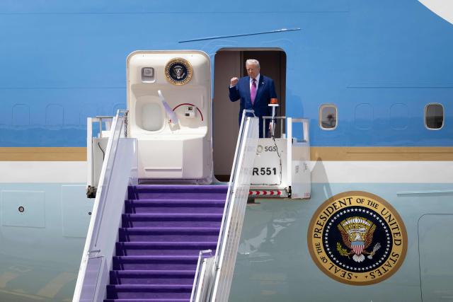 US President Donald Trump gestures as he exits his plane upon arriving at the airport in Riyadh on May 13, 2025. (Photo by Brendan Smialowski / AFP)