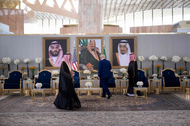 Saudi Crown Prince Mohammed bin Salman (R) and US President Donald Trump (C) walk to their seats ahead of a coffee ceremony in Riyadh on May 13, 2025. (Photo by Brendan Smialowski / AFP)
