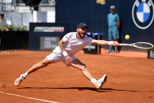 France's Corentin Moutet returns to Great Britain's Jack Draper during their men's singles match at the ATP Rome Open tennis tournament at Foro Italico in Rome on May 13, 2025. (Photo by Marco BERTORELLO / AFP)