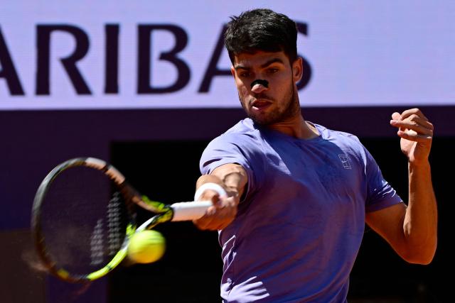 Spain's Carlos Alcaraz returns to Russia's Karen Khachanov during their men's singles match at the ATP Rome Open tennis tournament at Foro Italico in Rome on May 13, 2025. (Photo by PIERO CRUCIATTI / AFP)
